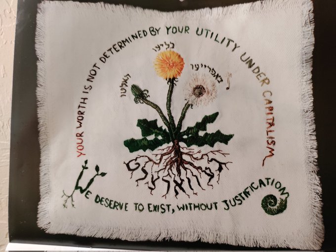 picture of needlework picture with words - Your worth is not determined by your utility under capitalism. We deserve to exist, without justification.